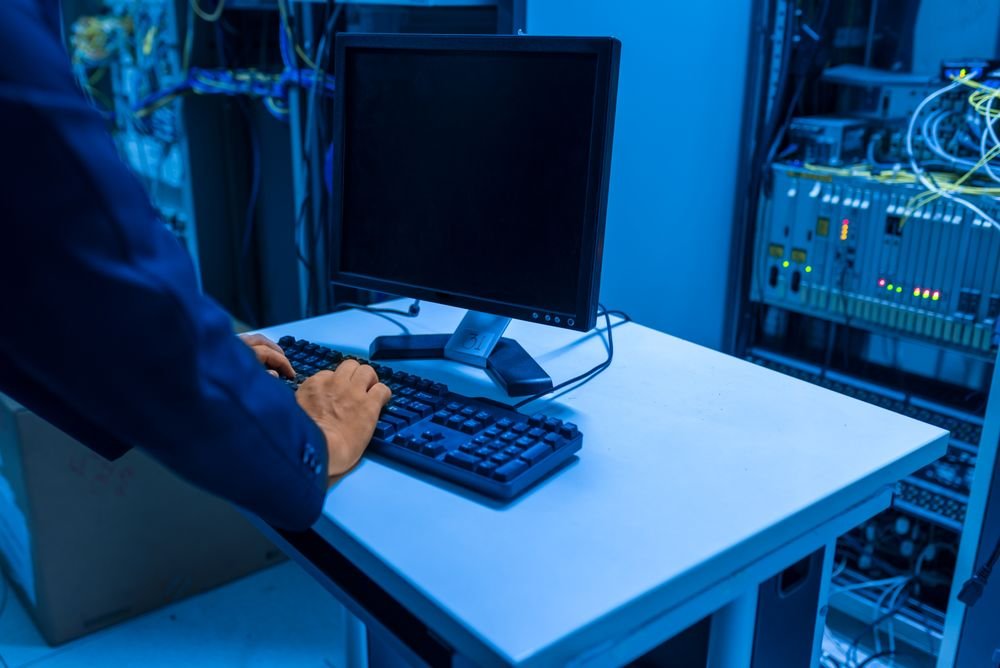 IT technician managing a data migration during post-merger integration