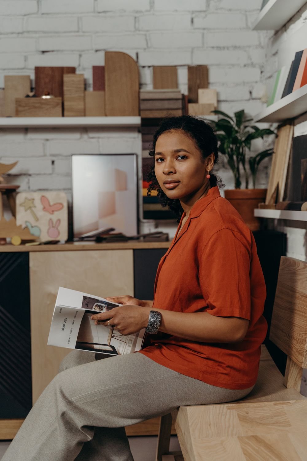 Woman in a furniture showroom holding a catalog
