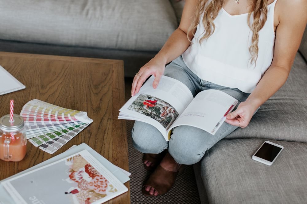 Woman reading with color swatches on a sofa