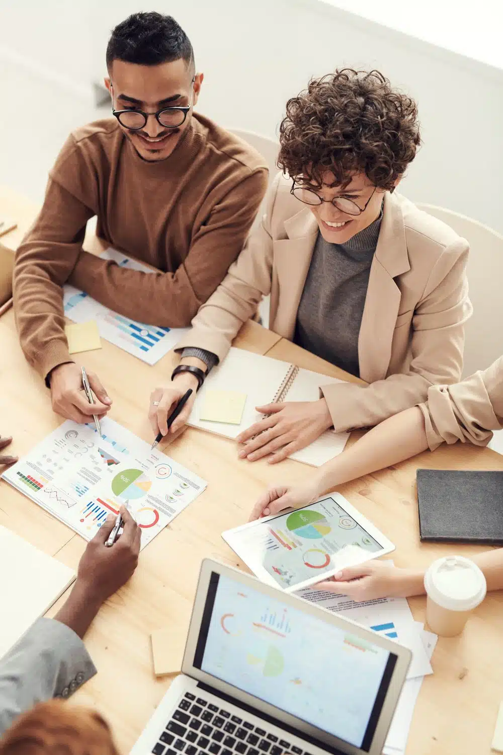 Group of professionals collaborating over charts in a meeting, illustrating the five-step process-first framing method