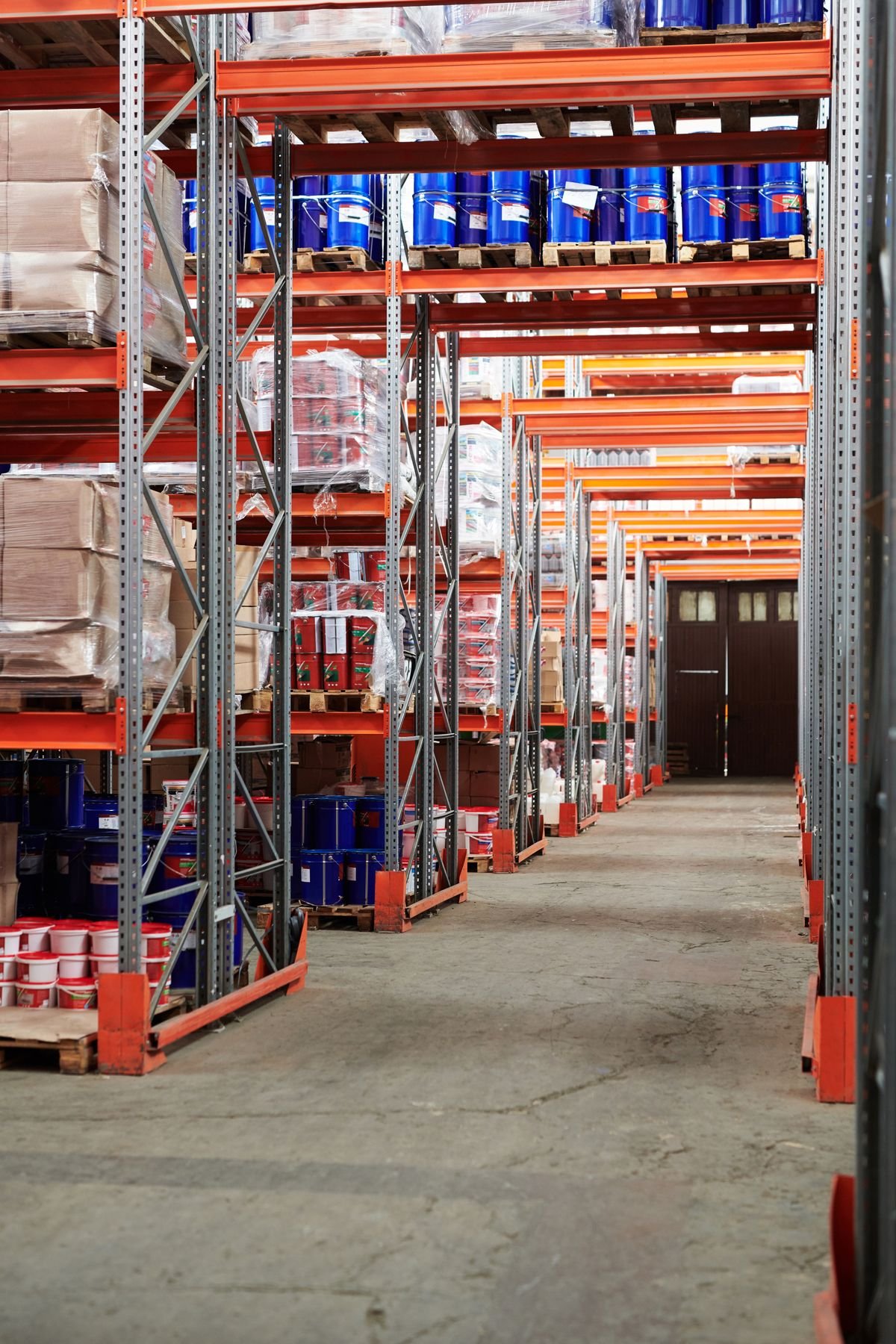 Warehouse aisle with stocked shelves and boxes, illustrating AI-driven inventory precision in retail - Notoriti