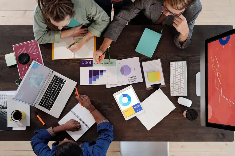 Team in a working meeting analyzing data, illustrating business process redesign ahead of AI integration